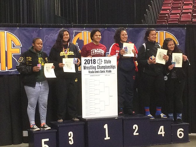 Madlyne Navarro standing on number 3 receives her medal at state championships