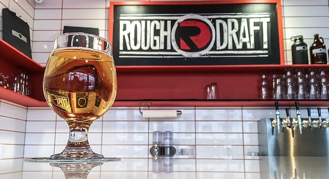 A glass of Mesa Nueva Mexican lager, brewed for the grad students attending Rough Draft's Mesa Nueva tasting room.