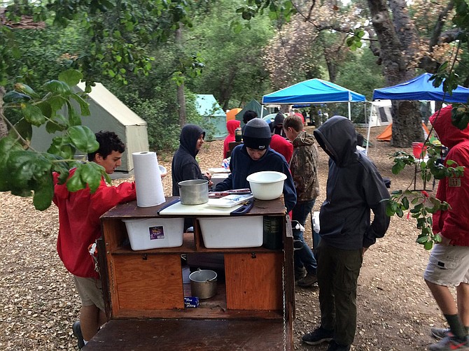 Troop 11 using the patrol box on a camping trip