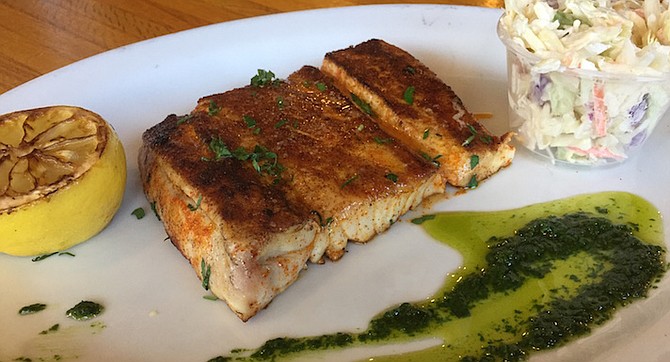 Grilled yellowtail served with an herb salsa verde
