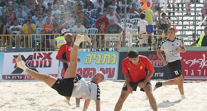 Players in Netanya, Israel compete in the sand.    

