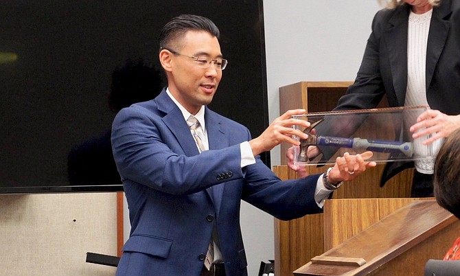 Prosecutor Keith Watanabe w the bloody hammer, sealed in container during trial. Photo by Eva.