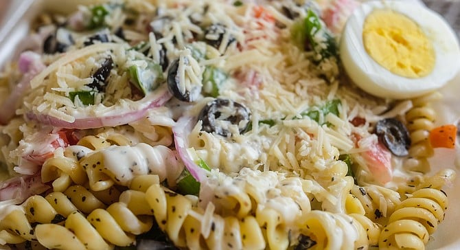 Trolley Stop Deli's full pasta salad includes olives, red onions, tomatoes, bell peppers, and eggs.