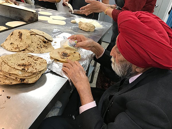 Everybody helps out at the temple meal: rich, poor, young, old