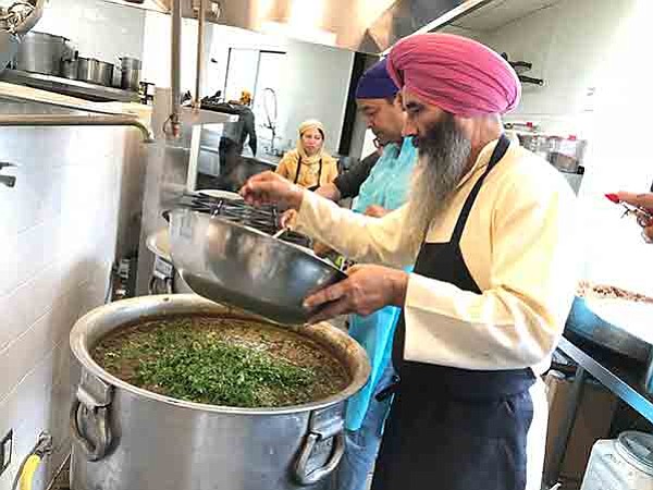 Salwinder Singh adds herbs to dal mix