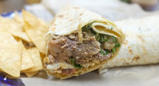 A 24-hour marinated lamb wrapped in a flour tortilla with pinto beans and rice.