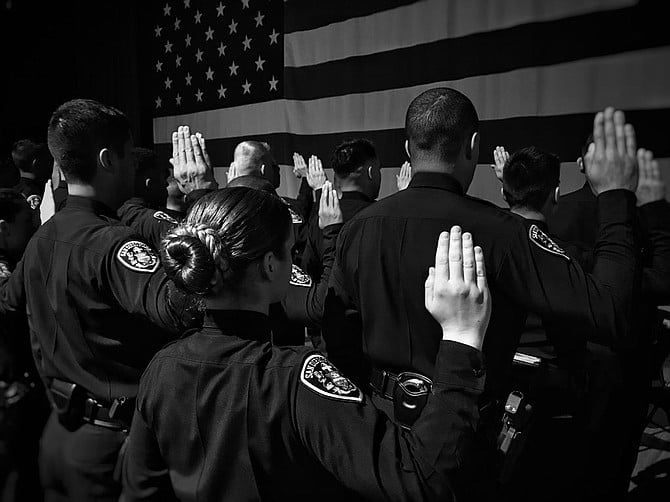 Officers taking the oath to protect and serve. 