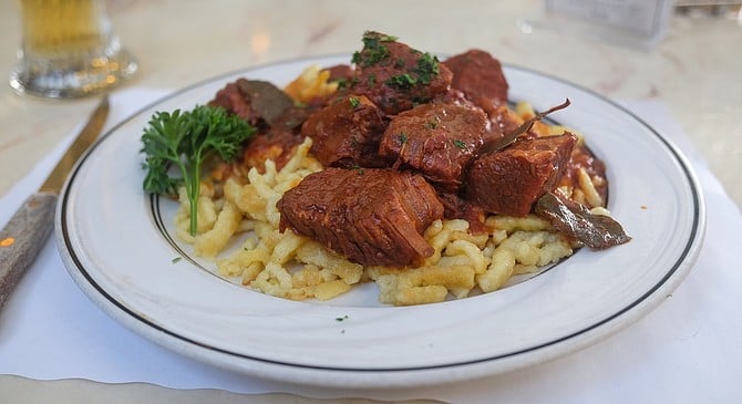 Tomato, onion, paprika, bay leaves, parsley, and stewed beef. The Hungarian dish, goulash, made and served in San Diego.