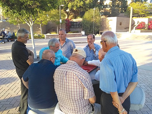 Chaldean men at backgammon game outside the courthouse off Main Street