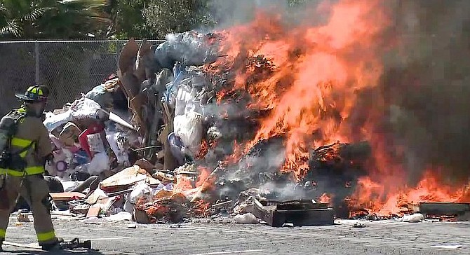 A San Diego firefighter moves to douse the garbage fire. The cause of the blaze is as yet unknown, but it’s probably something to do sexual harassment or national politics, or both.