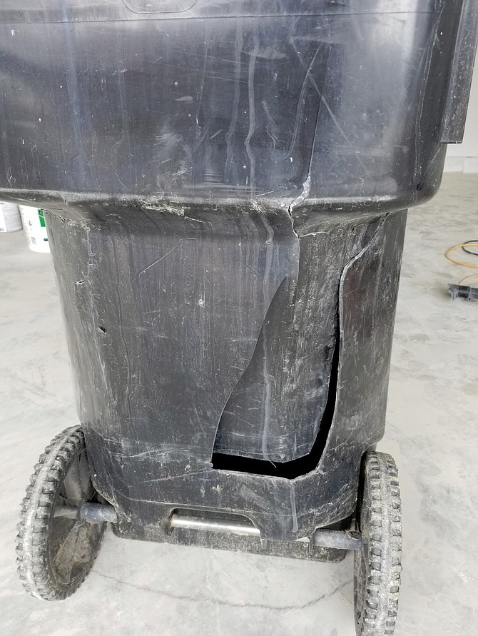 "The worker grabbed the can securely with those powerful truck mounted arms. A second later, he grabbed it again with the arms tighter." That second time, the trash can caved. 