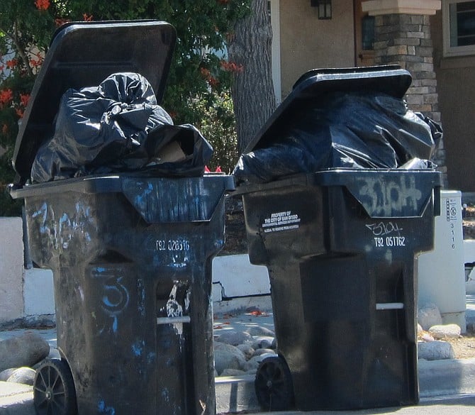 It's better for automated trash collection if the lid is shut. 