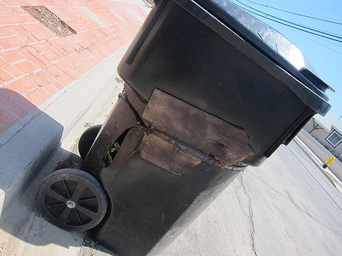 Norm made this repair with a plank and some metal on a trash can that is more than 15 years old. 