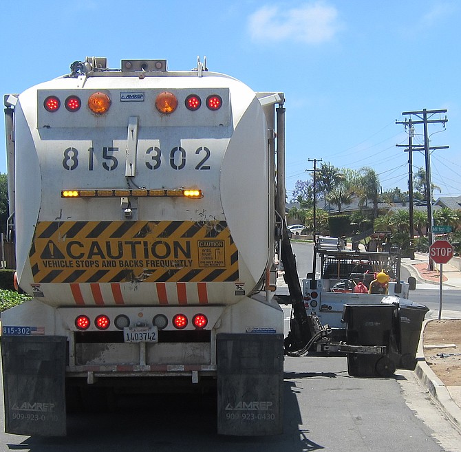 Once I got close-enough to take photos, the trash collector appeared to lift and lower the cans more gently. 