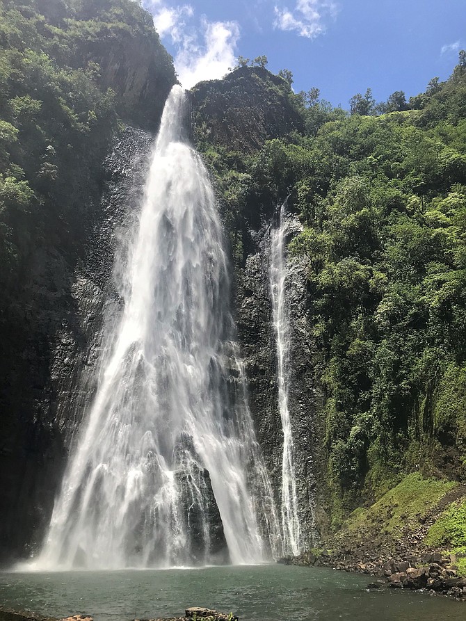 Feeling the power of Manawaiopuna waterfall (approx 375ft. tall waterfall).  In Kauai, Hawaii.