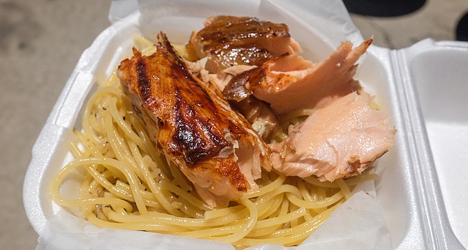A flaky, flame-frilled cedar plank salmon over noodles