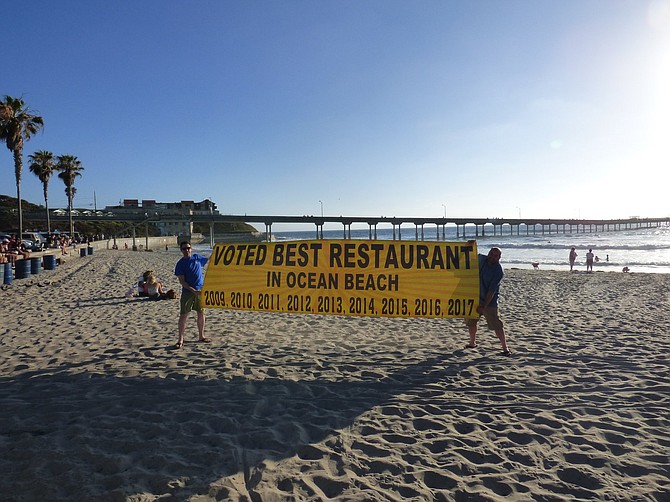 Nati's 12-foot "Voted Best Restaurant in Ocean Beach" banner was donated to the local town council for their annual holiday auction to raise money for food and toys for local families in need. (Nicole Ueno)
