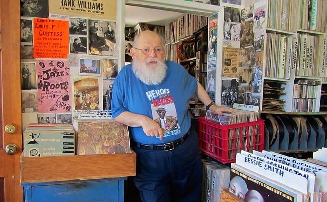 Lou Curtiss manning the record store in his Robert Crumb-drawn T-shirt (http://www.folkartsrarerecords.com)