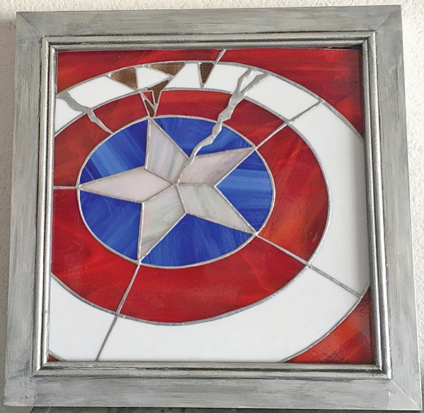 Battle-damaged stained-glass shield