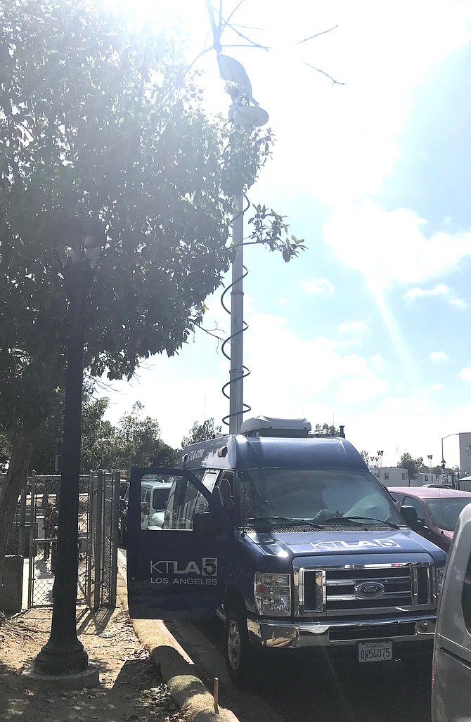 KTLA 5 news van parked on Park Boulevard by a red curb