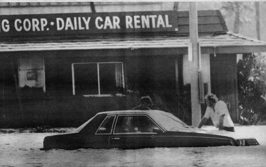 Mission Valley, 1980. A taxicab was swept away when the driver tried to ford a small road behind Fashion Valley shopping center.