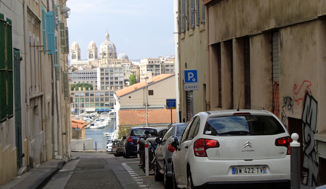 Narrow Marseille streets offer views of the harbor and monuments. 