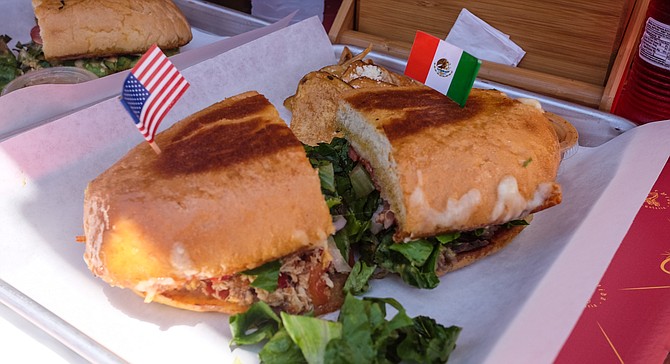 A La Forntera torta at El Carrito, with the Mexican flag planted on the carne asada half.