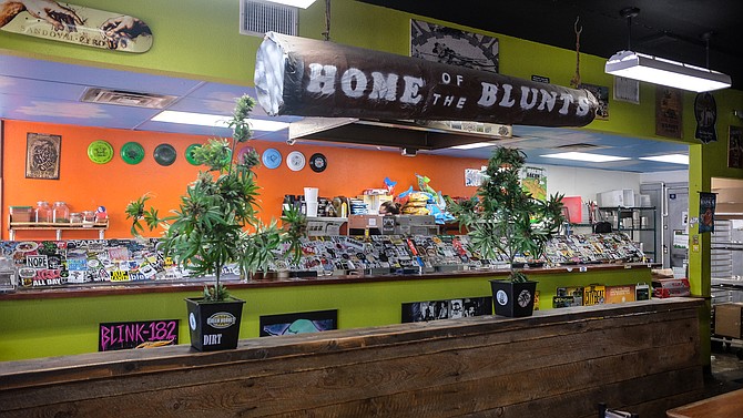 Cannabis references abound, including plastic plants.