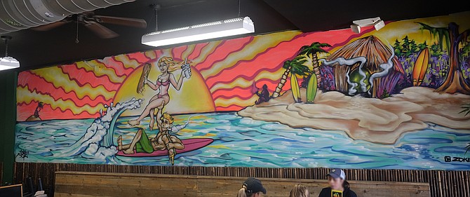 A smoking surfer mural at Cheba Hut