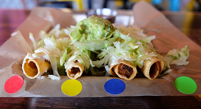 Color coded rolled tacos, from beef to vegan.