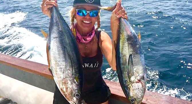 Katharina Eckert with a pair of football tunas caught aboard the Chief.