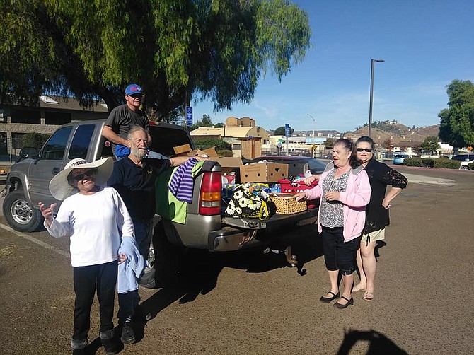 Lakeside Calvary Chapel volunteers donate food and clothes to homeless at Lindo Lake park.