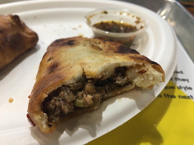 The beef empanada is filled with savory ground, onions and spices.