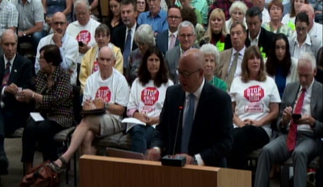 A team of well-connected ladies and lads have been lobbying the county hard for Newland. From June's meeting, Phil Rath at podium and city planning commissioner Jim Whalen in red tie in back.