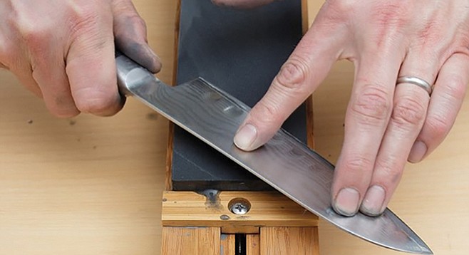 Sharpening Japanese knife on stone