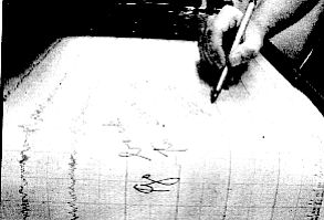 The polygraph holds a spool of unwinding paper; on it eight pens capture in ink the signals racing through the resting subject.