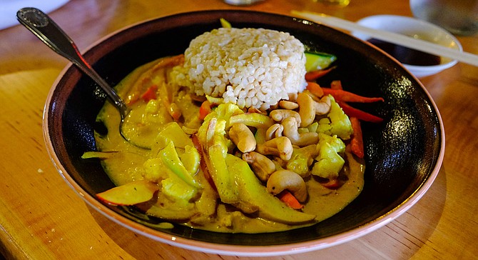 A yellow coconut curry with cashews and vegetables