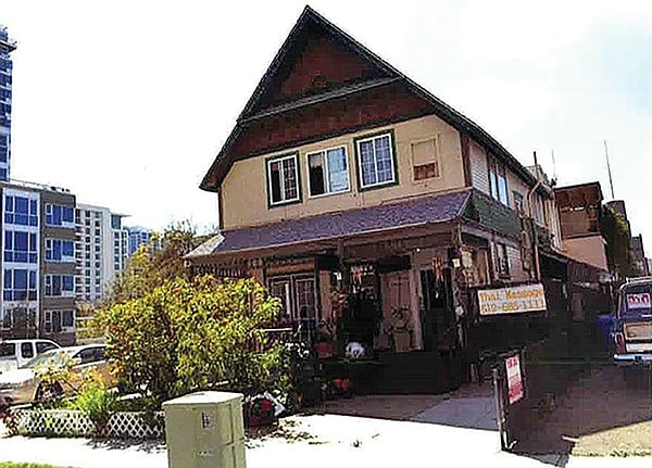 A massage parlor was located at the old Victorian house that was torn down to build the micro apartments.