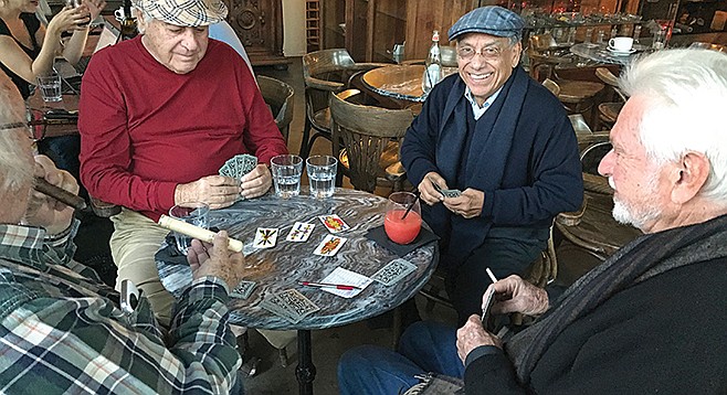 Four regular customers playing “Scopa,” the card game of Italy’s cafes