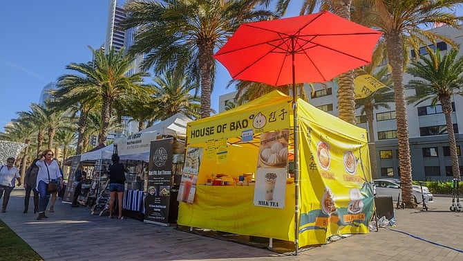 House of Bao joins other food vendors serving food beneath palm trees along Broadway