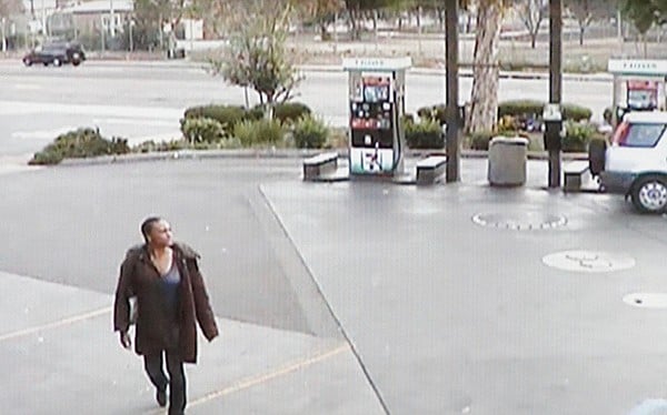 Surveillance video: Asiatae wore a long coat as she walked to corner stores that morning