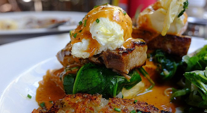 Pork belly, spinach, and poached egg, drenched in ancho chili hollandaise, over a cheddar and chive biscuit