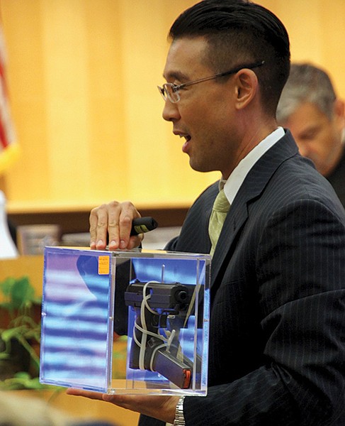 Prosecutor Keith Watanabe showed the murder weapon to the jury.