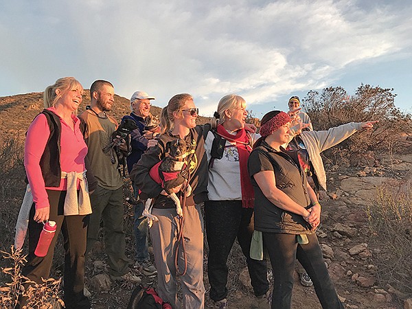 Kevin (3rd left), family, friends, dogs cheer moment of sun’s return from depths