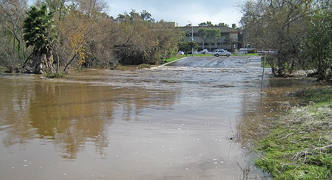 San Diego River flows over Avenida Del Rio in 2010. Typically, Mission Valley flooding is more of a traffic hassle than an aquatic apocalypse.