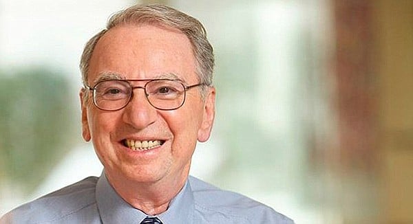 Irwin Jacobs is smiling because he has enough money to influence Republicans and Democrats alike.