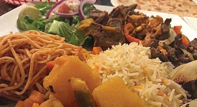 Potatoes, pasta, basmati rice, and salad surround the goat, beef and chicken suucqar