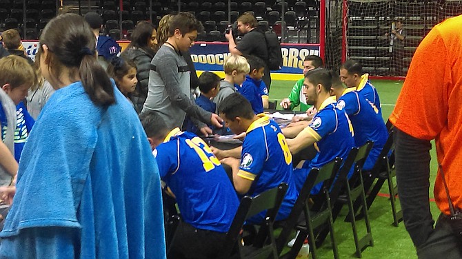 Sockers players sign autographs after the game