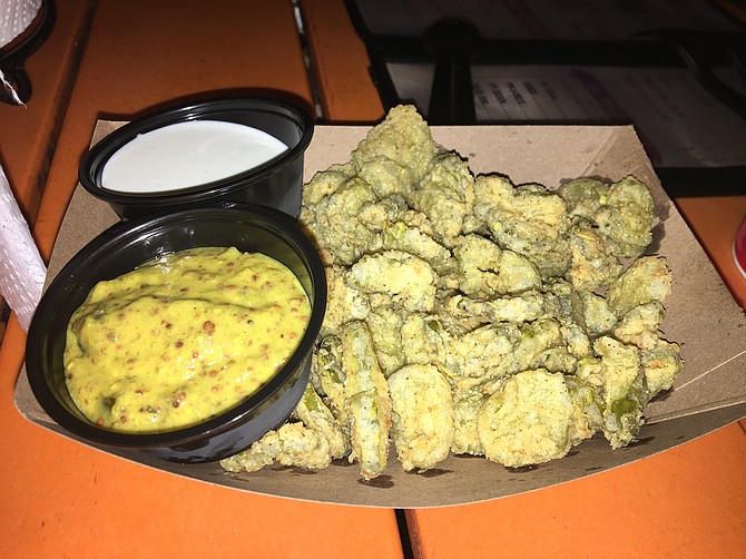 Lil Piggy's fried pickles come with both ranch dressing and a mustard sauce for dipping.