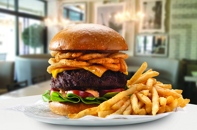 The Sugar Factory Burger at the Theatre Box comes with a half-pound of Angus beef, crispy onions on a brioche bun.